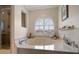 Relaxing bathtub area featuring a large window with shutter blinds and a separate glass door shower at 2102 S Fore Cir, Tampa, FL 33612