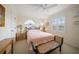 Cozy bedroom with plush pink bedding, ceiling fan and lots of natural light at 2102 S Fore Cir, Tampa, FL 33612