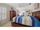 A bedroom featuring 2 twin beds with colorful striped comforters and dark wood furniture at 2102 S Fore Cir, Tampa, FL 33612