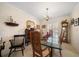 Formal dining room with chandelier and seating for four at 2102 S Fore Cir, Tampa, FL 33612