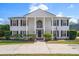 Stunning two-story home featuring a grand entrance with white columns and a manicured lawn at 2102 S Fore Cir, Tampa, FL 33612