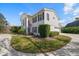 Beautiful exterior elevation with white columns, fresh green grass and a circular driveway at 2102 S Fore Cir, Tampa, FL 33612