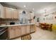 Kitchen with light wood cabinets, stainless appliances, and a cozy breakfast nook area at 2102 S Fore Cir, Tampa, FL 33612