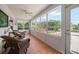 Bright sunroom surrounded by large windows overlooking beautiful yard at 2102 S Fore Cir, Tampa, FL 33612