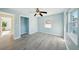 Spacious bedroom with large windows, closet, and light wood-look flooring at 2320 E Harbor S Dr, St Petersburg, FL 33705