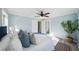 Cozy bedroom with a large window, a ceiling fan, and a view into the closet at 2320 E Harbor S Dr, St Petersburg, FL 33705