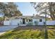 Quaint single-story home with well-manicured lawn, blue and white exterior, and attached garage at 2320 E Harbor S Dr, St Petersburg, FL 33705