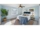 Stylish main bedroom features soft blue walls, rug, ceiling fan and natural light at 2320 E Harbor S Dr, St Petersburg, FL 33705