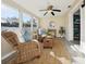 Relaxing sun room featuring wicker chairs, ceiling fan and sun-filled windows at 2320 E Harbor S Dr, St Petersburg, FL 33705