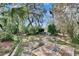 Secluded backyard featuring lush, mature landscaping, a bird bath, and a brick patio area perfect for entertaining at 2823 Clubhouse Dr, Plant City, FL 33566
