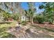 A serene backyard with a bird bath, brick-paved area, and lush landscaping, ideal for outdoor relaxation at 2823 Clubhouse Dr, Plant City, FL 33566