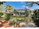 This backyard features a screened lanai, lush landscaping, and a well-maintained lawn at 2823 Clubhouse Dr, Plant City, FL 33566