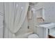 Bathroom with a white shower curtain, and tiled walls, creating a clean and functional space at 2823 Clubhouse Dr, Plant City, FL 33566