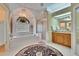 Bright bathroom featuring a soaking tub, glass shower, and wood vanity at 2823 Clubhouse Dr, Plant City, FL 33566