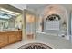 Bright bathroom featuring a soaking tub, glass shower, and wood vanity at 2823 Clubhouse Dr, Plant City, FL 33566