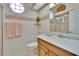 Well-lit bathroom featuring a sink, vanity, toilet, and a glass-enclosed shower at 2823 Clubhouse Dr, Plant City, FL 33566