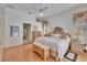 Bright bedroom with hardwood floors, neutral decor, and a bathroom suite at 2823 Clubhouse Dr, Plant City, FL 33566