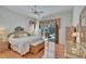 Bedroom with natural light, hardwood floors, and a view of the pool at 2823 Clubhouse Dr, Plant City, FL 33566