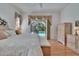 Bedroom with hardwood floors, neutral decor, and a view of the pool at 2823 Clubhouse Dr, Plant City, FL 33566
