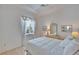 Bright bedroom with white walls, a queen bed, and neutral-toned furniture at 2823 Clubhouse Dr, Plant City, FL 33566