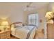 Bright bedroom featuring a comfortable bed, soft lighting, and a window with sheer curtains at 2823 Clubhouse Dr, Plant City, FL 33566