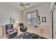 Cozy bedroom featuring two leather chairs, a decorative rug, and a neutral color scheme at 2823 Clubhouse Dr, Plant City, FL 33566
