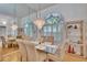 Elegant dining room with a glass table, six chairs and beautiful chandelier at 2823 Clubhouse Dr, Plant City, FL 33566