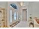 Bright foyer featuring a tiled floor, chandelier, mirrored accents and decorative shelving at 2823 Clubhouse Dr, Plant City, FL 33566
