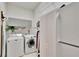 Functional laundry room equipped with washer, dryer, cabinets, and storage space at 2823 Clubhouse Dr, Plant City, FL 33566