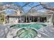 Enclosed pool area featuring a swimming pool and hot tub, with ample seating and entertainment space at 2823 Clubhouse Dr, Plant City, FL 33566