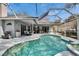 The screened-in pool has a built-in spa, patio furniture, ceiling fans, and outdoor dining area at 2823 Clubhouse Dr, Plant City, FL 33566