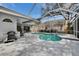 Screened-in pool and hot tub area with outdoor kitchen, BBQ, and seating, perfect for entertaining guests at 2823 Clubhouse Dr, Plant City, FL 33566