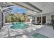Screened-in pool area featuring a swimming pool, hot tub, and outdoor seating area, perfect for relaxation at 2823 Clubhouse Dr, Plant City, FL 33566