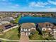 Aerial view of a lakefront community with lush landscaping and beautiful homes at 28565 Picana Ln, Wesley Chapel, FL 33543