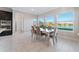 Dining room with a water view and lots of natural light, tile floors, and modern finishes at 28565 Picana Ln, Wesley Chapel, FL 33543