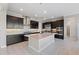 A modern kitchen with a kitchen island, stainless steel appliances, and dark wood cabinetry at 28565 Picana Ln, Wesley Chapel, FL 33543