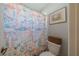 Charming bathroom features a fun, ocean-themed shower curtain and cozy basket for a delightful, beachy vibe at 3017 Minuteman Ln, Brandon, FL 33511