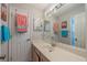 Bright bathroom featuring a large vanity, mirrors, and a variety of colorful towels at 3017 Minuteman Ln, Brandon, FL 33511
