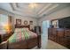 Comfortable bedroom featuring a ceiling fan, a colorful bedspread, and wooden furniture at 3017 Minuteman Ln, Brandon, FL 33511