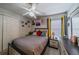 Cozy bedroom with a comfortable bed, ceiling fan, and natural light, creating a relaxing retreat at 3017 Minuteman Ln, Brandon, FL 33511