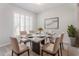 Dining area featuring a concrete-look table set for six, plantation shutters, and modern décor at 3017 Minuteman Ln, Brandon, FL 33511