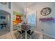 Bright dining room featuring unique lighting, a square table, a window, and colorful decor at 3017 Minuteman Ln, Brandon, FL 33511