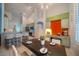 Dining room with modern light fixture, set table, and an open view of the kitchen at 3017 Minuteman Ln, Brandon, FL 33511