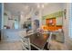 Dining room with modern light fixture, work station, and an open view of the kitchen at 3017 Minuteman Ln, Brandon, FL 33511