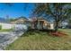 Charming single-story home with lush lawn, mature tree, and a two-car garage at 3017 Minuteman Ln, Brandon, FL 33511