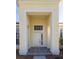 Inviting front entrance with a white door, stone walkway, and a bright and airy portico at 3017 Minuteman Ln, Brandon, FL 33511