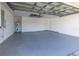 Spacious and clean garage with painted floor, water heater, electrical panel, and door to the house at 3017 Minuteman Ln, Brandon, FL 33511