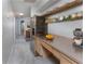 Hallway featuring carpeted floors, a stainless steel refrigerator, and floating shelves at 3017 Minuteman Ln, Brandon, FL 33511