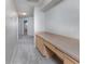 Hallway featuring carpeted floors, a built-in desk area, and access to other rooms at 3017 Minuteman Ln, Brandon, FL 33511