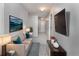 Comfortable hallway boasts a cozy couch, TV, and stylish decor for relaxation and entertainment at 3017 Minuteman Ln, Brandon, FL 33511